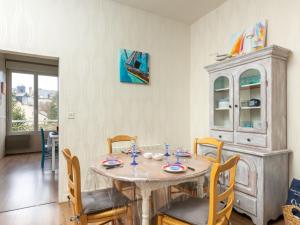 a dining room with a table and chairs at Apartment Couleurs de la Baie by Interhome in Cancale