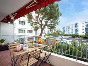a balcony with a table and chairs on a balcony at Apartment Epsom by Interhome in Cagnes-sur-Mer