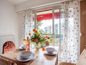 a dining room with a table and a window at Apartment Epsom by Interhome in Cagnes-sur-Mer