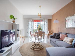 a living room with a couch and a table at Apartment Epsom by Interhome in Cagnes-sur-Mer