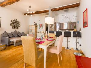 a dining room and living room with a table and chairs at Apartment Le Mascoïnat by Interhome in Nice