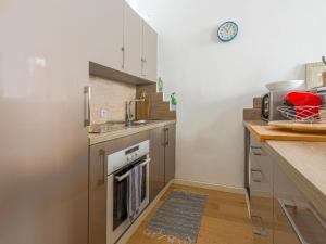 a kitchen with a sink and a stove top oven at Apartment Le Mascoïnat by Interhome in Nice
