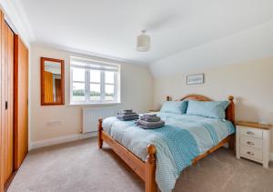 a bedroom with a bed and a window at Sailors Rest in Wangford