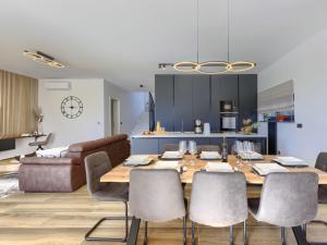 a kitchen and dining room with a table and chairs at Villa Prudensia by Interhome in Kaštelir