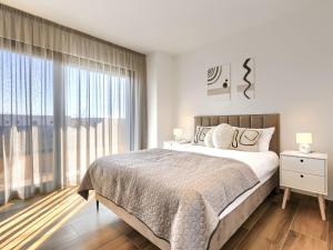 a bedroom with a bed and a large window at Villa Prudensia by Interhome in Kaštelir