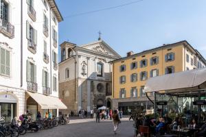 a city street with buildings and people walking around at Centro storico · Leonardo House in Bergamo