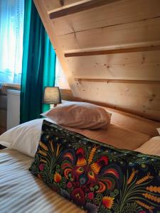 a bedroom with a bed with a wooden headboard at U Dziadka in Chochołów