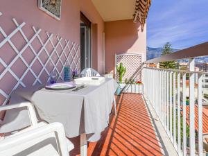 a white table on the balcony of a house at Apartment La plage du Cap by Interhome in Roquebrune-Cap-Martin