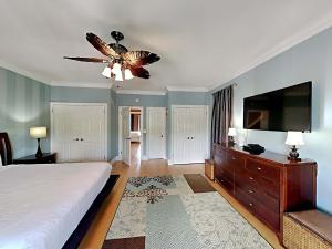 a bedroom with a bed and a flat screen tv at A Mid-Summer's Night Dream in Destin