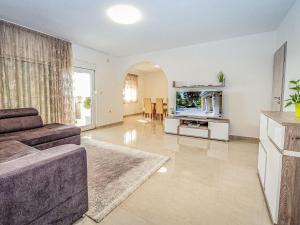 a living room with a couch and a tv at Holiday Home Villa Laura by Interhome in Benkovac