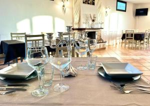 a table with wine glasses and plates on it at La Collina sul Mare in Palma di Montechiaro