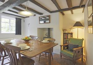 a dining room with a wooden table and chairs at Sherfield Cottage in Snape