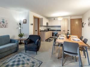 a living room with a table and chairs and a kitchen at Apartment Condominio Giulia by Interhome in Alba di Canazei +25 photos