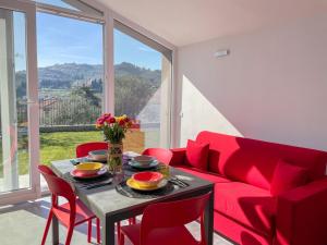 a living room with a red couch and a table at Holiday Home Casa Luca by Interhome in Imperia