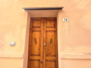 a wooden door with the number on the side of a building at Apartment Bilocale dell'Arco by Interhome in Massa Marittima