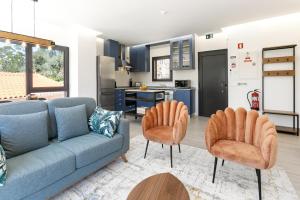 a living room with a couch and two chairs at Maria da Vinha - Country House in Góis