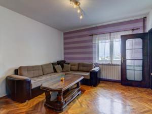 a living room with a couch and a coffee table at Apartment Miškulin-5 by Interhome in Senj