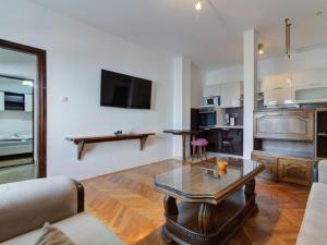 a living room with a couch and a coffee table at Apartment Miškulin-5 by Interhome in Senj +36 photos