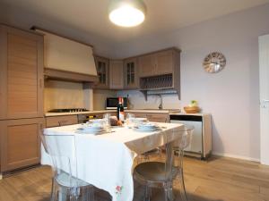 a kitchen with a white table and chairs in it at Apartment Cinzia by Interhome in Santa Maria a Monte +21 photos