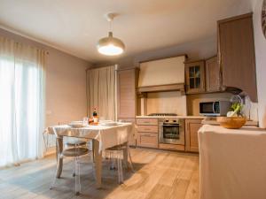 a kitchen with a white table and chairs in a room at Apartment Cinzia by Interhome in Santa Maria a Monte