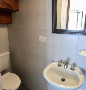 a bathroom with a sink and a toilet at Duplex en Alquiler Pinamar in Pinamar