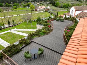 an aerial view of a patio with a table and chairs at Lavandeira Douro Nature & Wellness in Baião