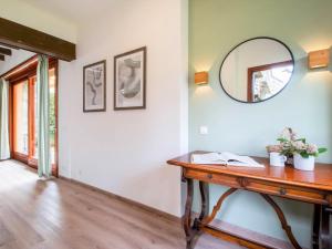 a room with a table and a mirror on the wall at Holiday Home Villa Camelia by Interhome in Porto Valtravaglia +39 photos