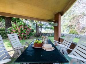 a table with a basket of fruit on a porch at Holiday Home Villa Camelia by Interhome in Porto Valtravaglia