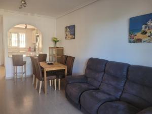 uma sala de estar com um sofá e uma mesa em Palmerita 5 em Mar de Cristal