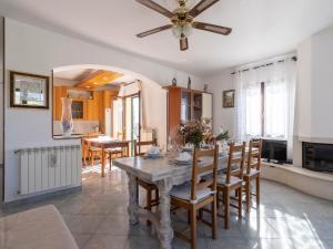 a kitchen and dining room with a table and chairs at Apartment Aurora by Interhome in Costarainera