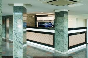 a kitchen with marble walls and a counter top at Laguna Hotel in Magnitogorsk