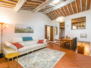a living room with a white couch and a table at Holiday Home Casa Campau by Interhome in Montepulciano