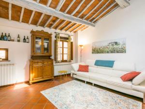a living room with a white couch and a table at Holiday Home Casa Campau by Interhome in Montepulciano