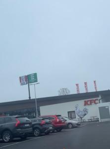 a parking lot with cars parked in front of a building at Tway luxury homes in Jönköping