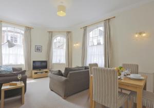 a living room with a couch and a table at Stones Throw in Southwold