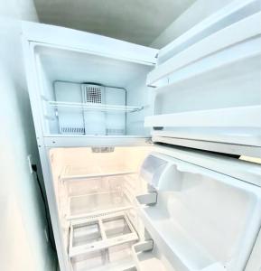 an empty refrigerator with its door open with the door open at Coral Gables / Coconut Grove area FREE parking in Miami