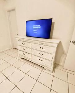 a television on top of a dresser in a room at Coral Gables / Coconut Grove area FREE parking in Miami