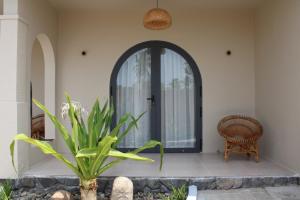 an entry to a house with a door and a plant at escVACA - Your Stay in Mui Ne in Mui Ne