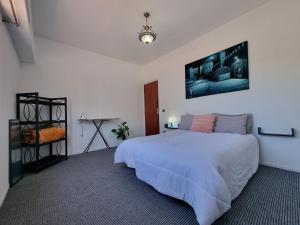 a bedroom with a large white bed and a table at Spacious 2 BR near mausolée med V, 1min walk tram. in Rabat