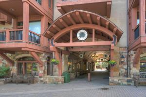 a building with balconies and tables and benches on a street at Arrowhead Village at Beaver Creek in Edwards