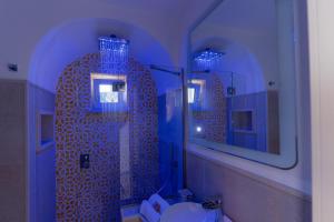 a bathroom with a toilet and two mirrors at Suite Belvedere Capri Exclusive Rooms in Capri