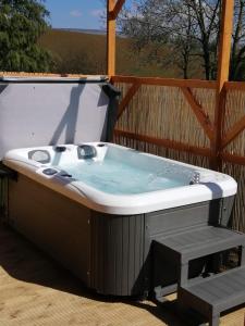 a jacuzzi tub sitting on a deck at Lakes and Eden Valley. Thornhill Cabin in Long Marton