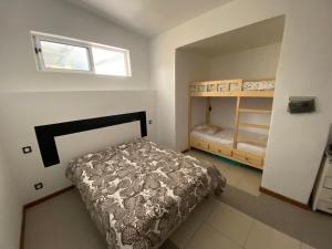 a small bedroom with a bed and a window at Casa Chiquinha in Ribeira da Prata