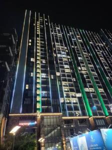 un edificio alto por la noche con luces verdes en Smart Apartment-District 7, en Ho Chi Minh