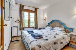 a bedroom with a large bed with pillows on it at La Isla Casa Barnaby in Platja de l'Arenal +52 photos