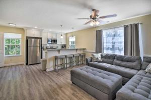 a living room with a couch and a kitchen at Cozy Cape Charles Apartment Walk to Beaches! in Cape Charles