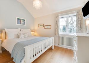 a bedroom with a white bed and a window at Sundial Lodge in Wilby