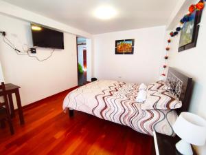 Voodi või voodid majutusasutuse Qolmay Hostel Cusco toas