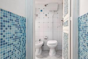 a bathroom with a white toilet and a sink at Piazza Pretoria & Quattro Canti Roomy Flats with Balconies in Palermo