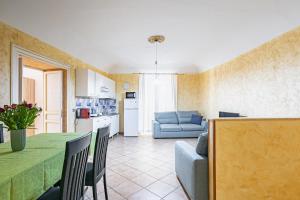 a kitchen and living room with a table and a couch at Piazza Pretoria & Quattro Canti Roomy Flats with Balconies in Palermo